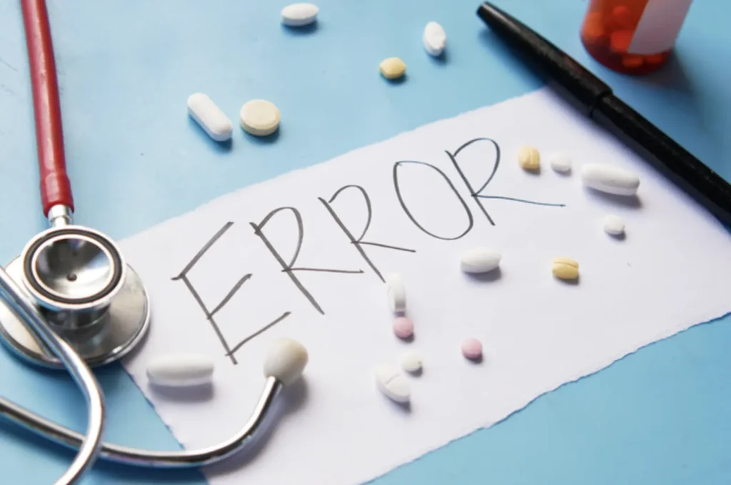 Madicans Spread on the Doctor Table and Writing Text on the Paper - Error