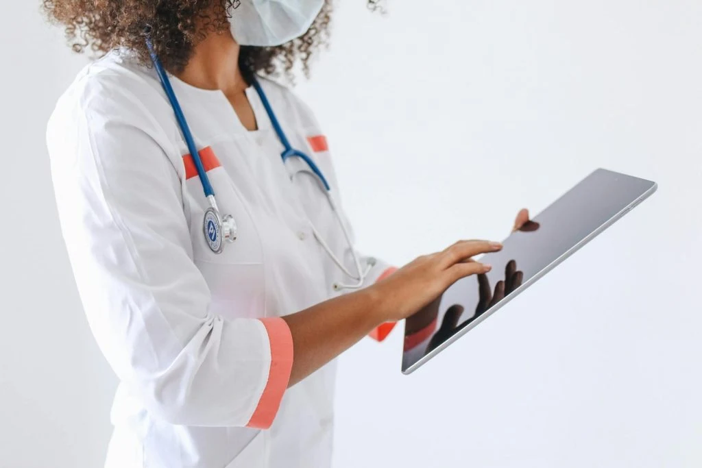Doctor reviewing patient information on a tablet